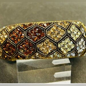 Cuff bracelet with a honeycomb pattern and amber-colored rhinestones